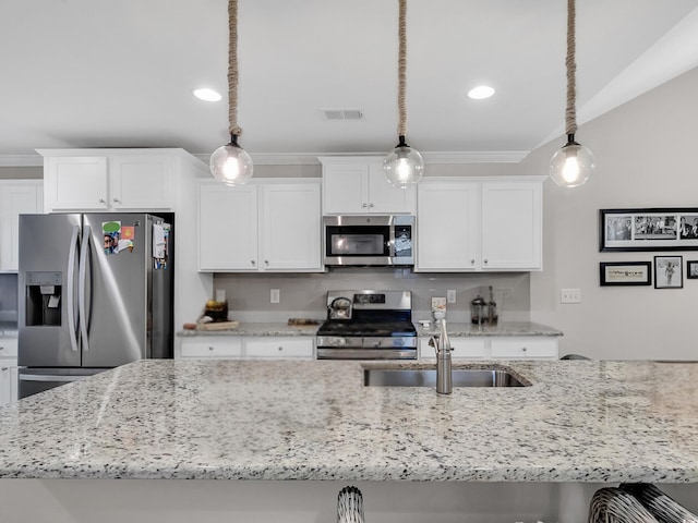 kitchen with sink, white cabinetry, decorative light fixtures, and stainless steel appliances