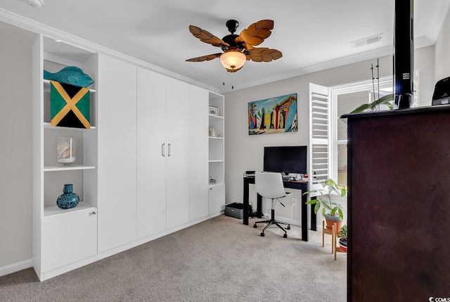 office space featuring ceiling fan, light carpet, built in features, and crown molding