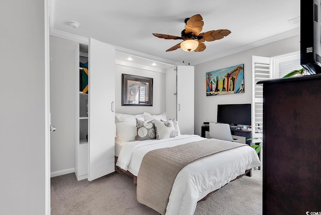 carpeted bedroom with ornamental molding and ceiling fan