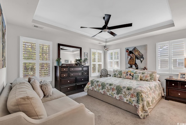 bedroom with light carpet, multiple windows, and ceiling fan