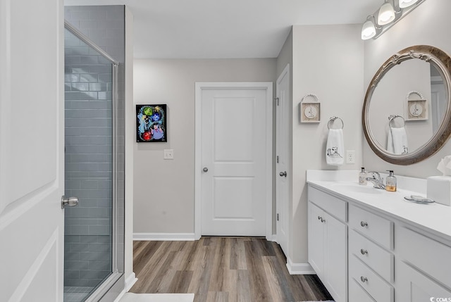 bathroom featuring vanity, a shower with shower door, and hardwood / wood-style flooring