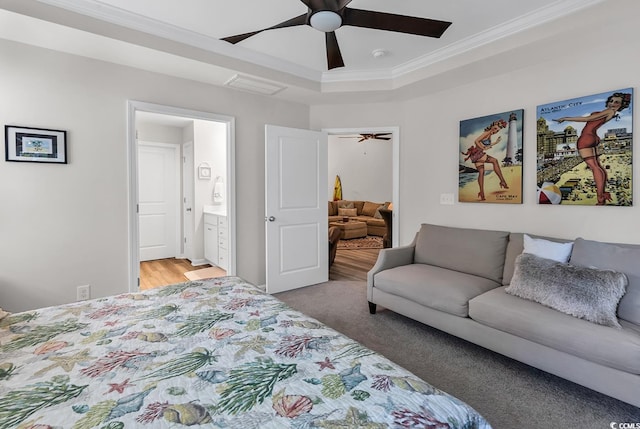 bedroom with ornamental molding, ensuite bathroom, hardwood / wood-style flooring, and ceiling fan