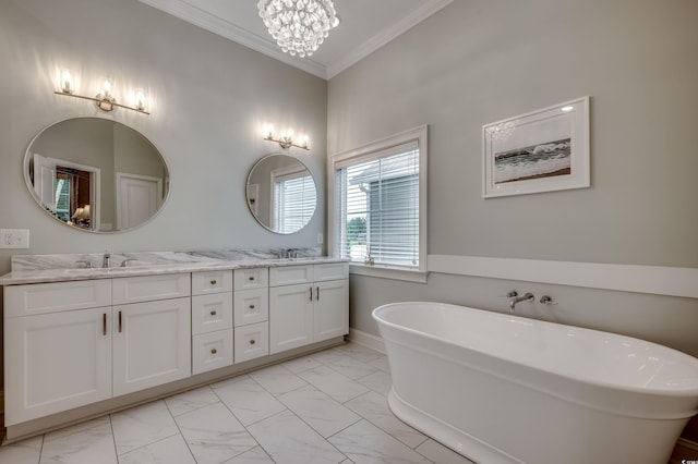 bathroom with ornamental molding, an inviting chandelier, vanity, and a bathing tub