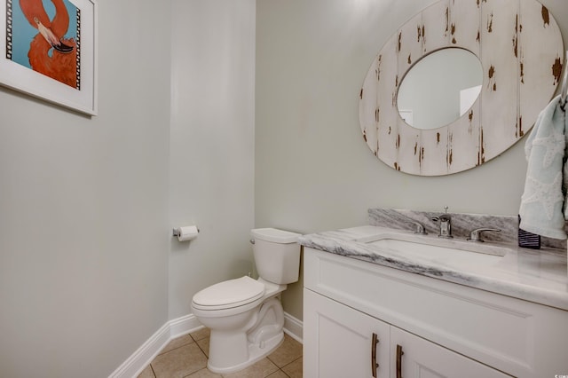 bathroom with tile patterned floors, vanity, and toilet