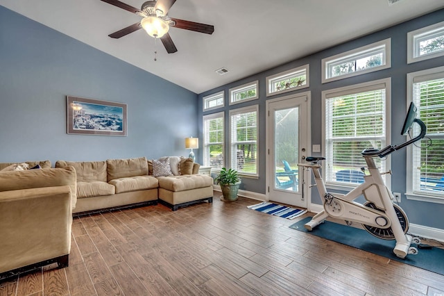 living room featuring wood-type flooring, ceiling fan, vaulted ceiling, and a healthy amount of sunlight