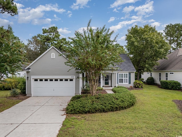 view of front of home with a front yard and a garage