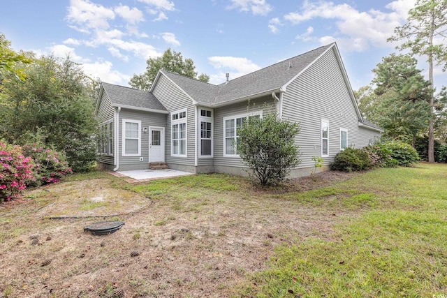 back of house featuring a yard and a patio area