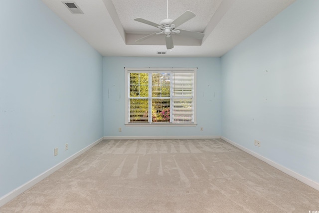 carpeted spare room featuring ceiling fan and a textured ceiling