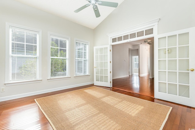 unfurnished room featuring wood-type flooring, french doors, high vaulted ceiling, and ceiling fan