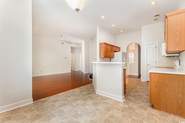 kitchen featuring white appliances, light wood-type flooring, and ceiling fan