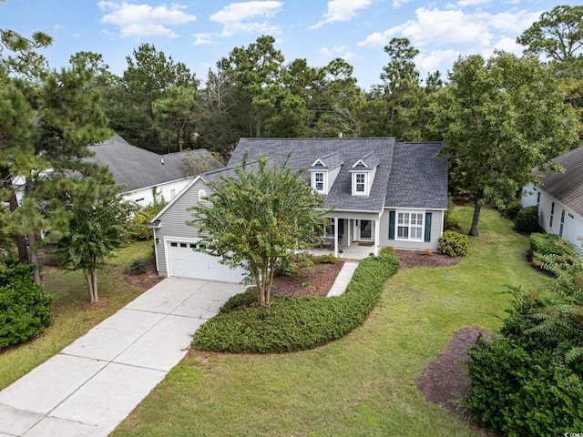 view of front of home featuring a garage, a front lawn, and covered porch