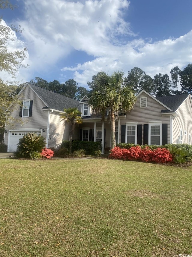 view of front of house with a front lawn and a garage