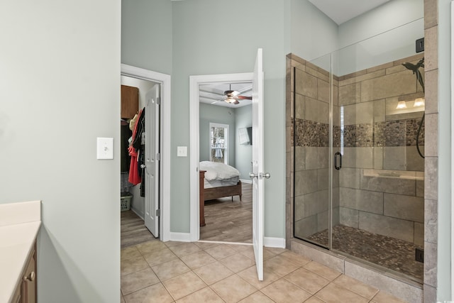 bathroom with vanity, tile patterned floors, ceiling fan, and walk in shower