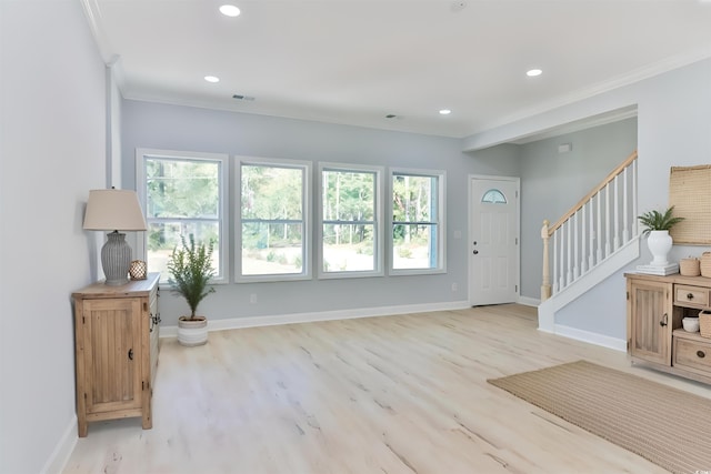 foyer featuring light hardwood / wood-style flooring and ornamental molding