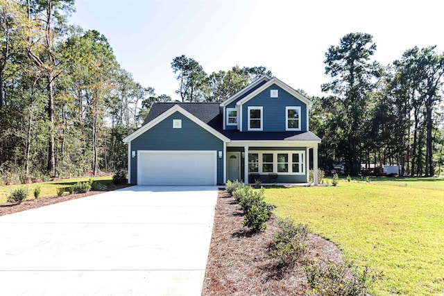 view of front of property featuring a front lawn and a garage