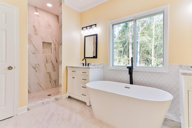 bathroom with vanity, crown molding, shower with separate bathtub, and tile walls