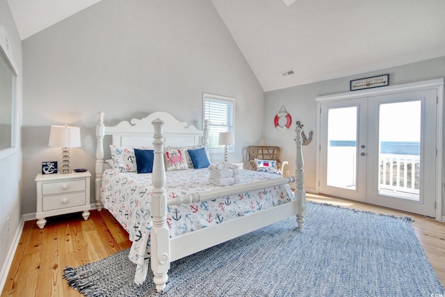 bedroom featuring access to outside, french doors, multiple windows, and light hardwood / wood-style flooring