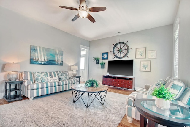 living room featuring hardwood / wood-style flooring and ceiling fan