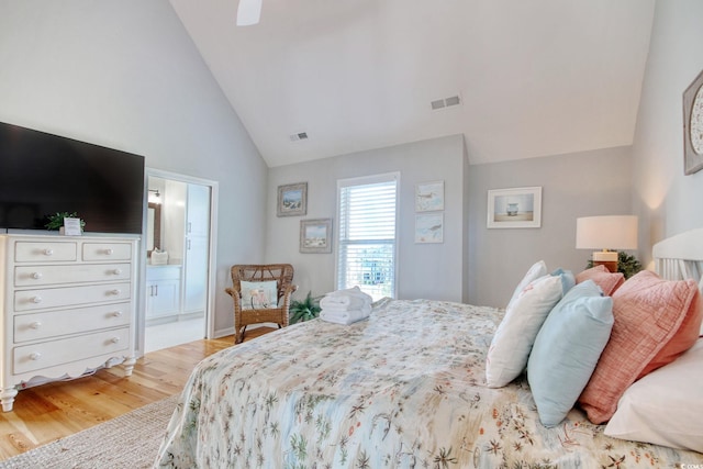 bedroom with connected bathroom, ceiling fan, high vaulted ceiling, and hardwood / wood-style floors