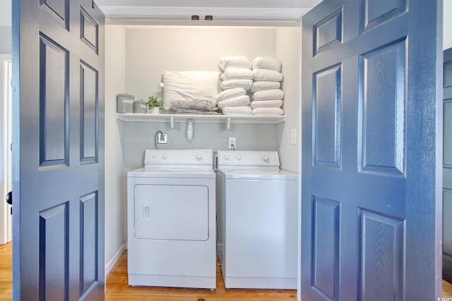 laundry room featuring washer and dryer and light hardwood / wood-style floors