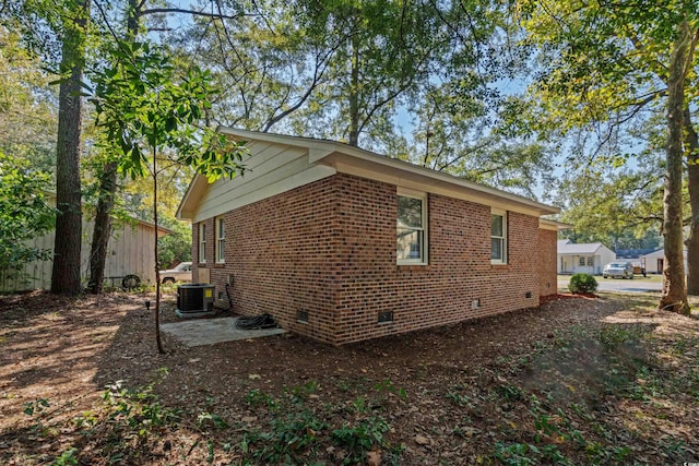 view of side of home with central AC unit