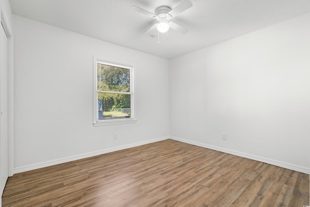 spare room featuring ceiling fan and wood-type flooring