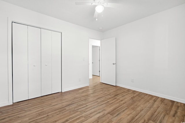 unfurnished bedroom featuring a closet, ceiling fan, and light wood-type flooring