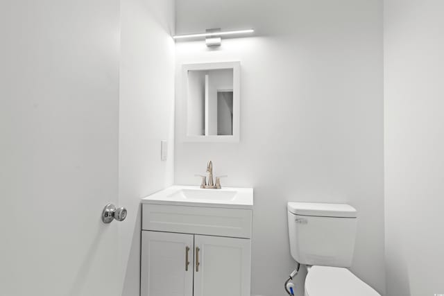 bathroom featuring toilet and vanity