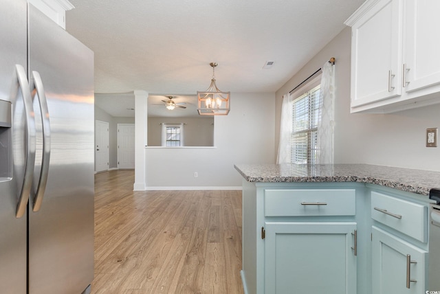 kitchen with decorative light fixtures, stainless steel fridge with ice dispenser, light wood-type flooring, ceiling fan with notable chandelier, and white cabinets