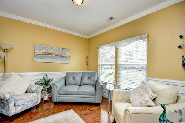 sitting room featuring crown molding and wood-type flooring