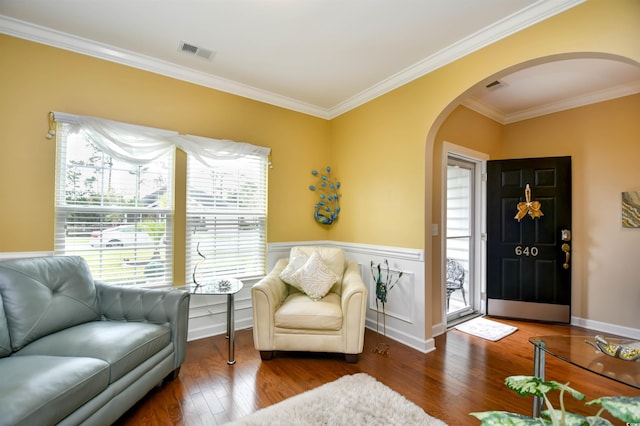 living area with ornamental molding and dark hardwood / wood-style flooring