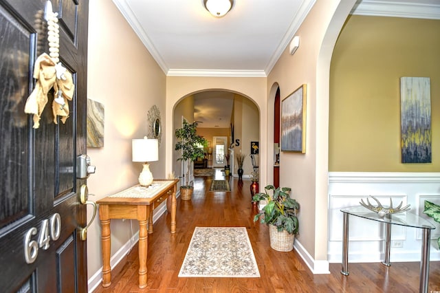 foyer featuring crown molding and hardwood / wood-style flooring