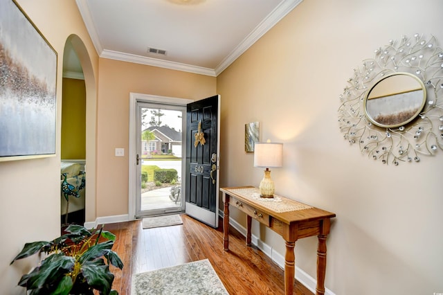 entryway featuring crown molding and light hardwood / wood-style floors