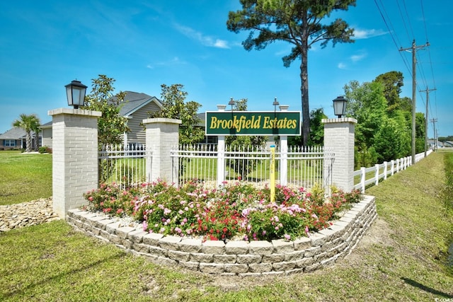 community / neighborhood sign with a yard