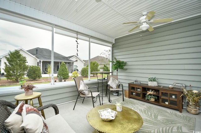 sunroom featuring ceiling fan