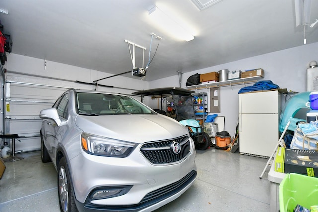 garage featuring white refrigerator and a garage door opener