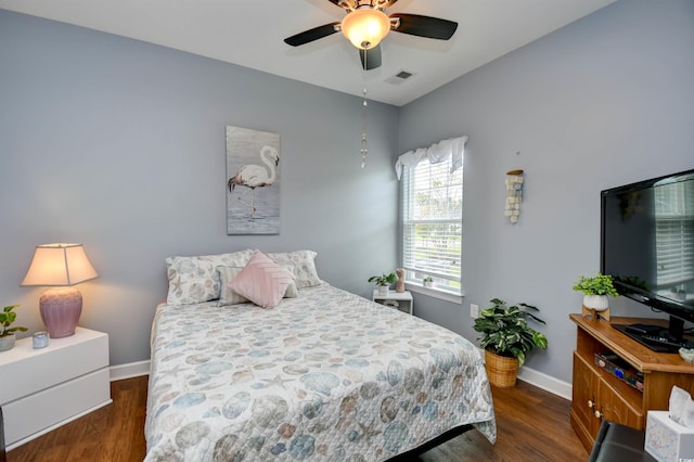 bedroom with dark hardwood / wood-style floors and ceiling fan