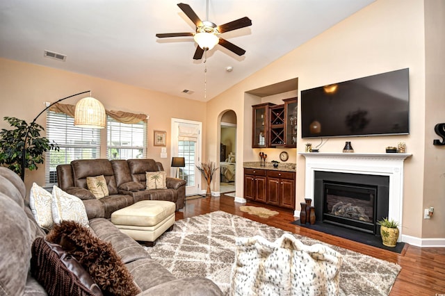 living room featuring lofted ceiling, ceiling fan, and dark hardwood / wood-style floors