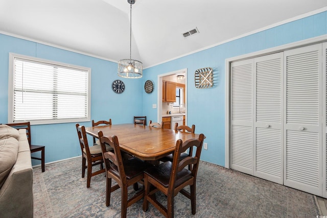 dining room featuring a notable chandelier, baseboards, ornamental molding, visible vents, and lofted ceiling