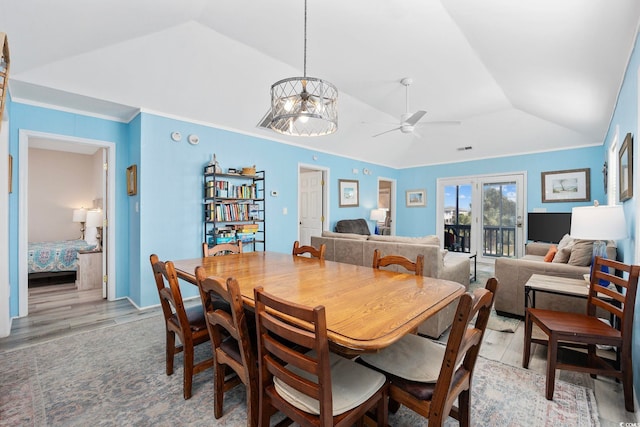 dining room featuring light wood-style floors, ceiling fan, crown molding, and lofted ceiling