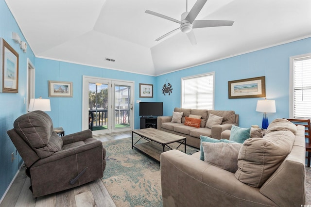 living room with wood finished floors, ceiling fan, lofted ceiling, and a wealth of natural light