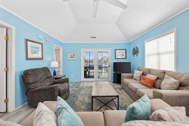 living room featuring visible vents, crown molding, vaulted ceiling, wood finished floors, and french doors