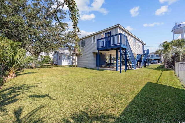 back of property featuring a patio, stairs, a wooden deck, a yard, and fence