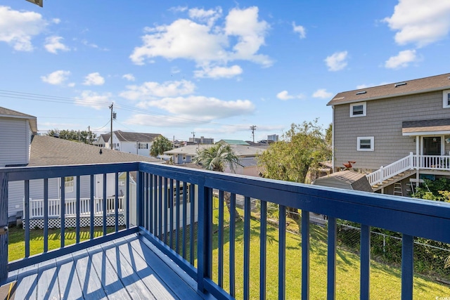 deck featuring a residential view and a yard