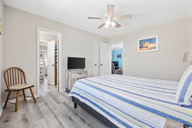 bedroom with light hardwood / wood-style floors and ceiling fan