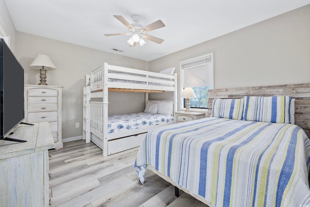 bedroom featuring visible vents, a ceiling fan, and wood finished floors