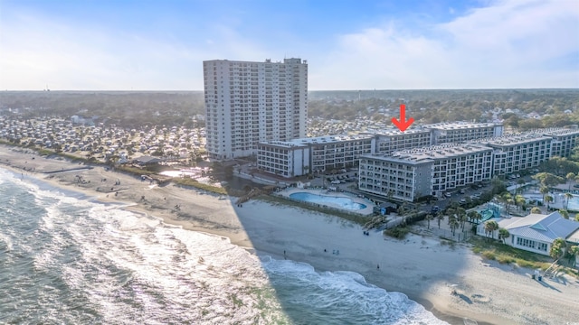 birds eye view of property with a water view and a view of the beach