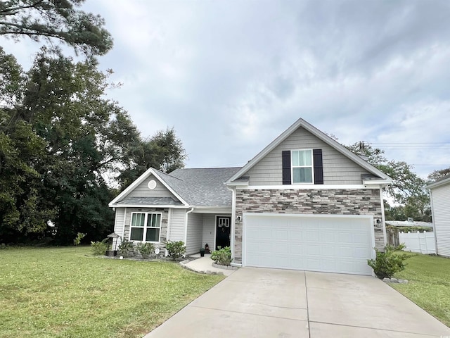 view of front of property with a front yard and a garage