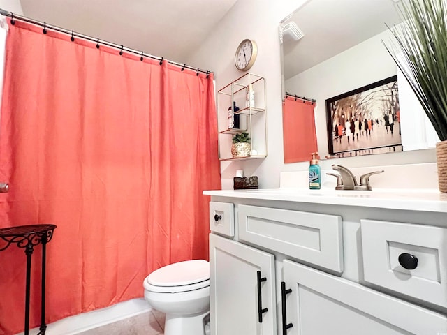 bathroom featuring toilet, walk in shower, vanity, and tile patterned flooring