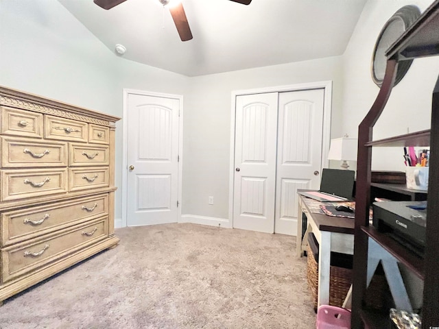 home office featuring ceiling fan, vaulted ceiling, and light colored carpet